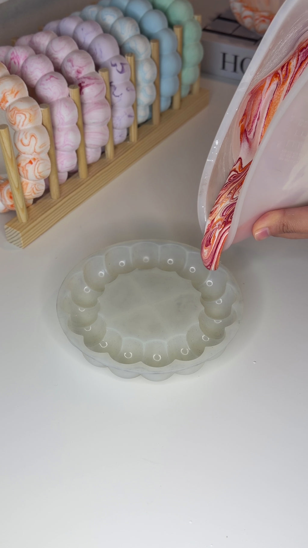 Bubble mirror / coaster mold — red-orange cast reel