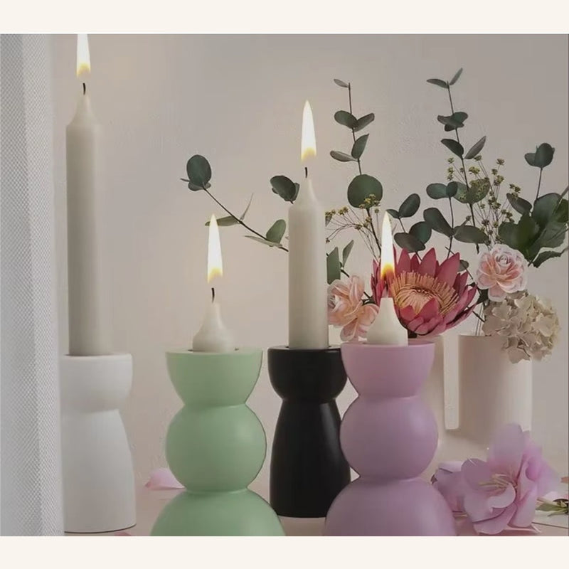 Modern candle holder casts in sage green, lilac and black for home decor inspiration